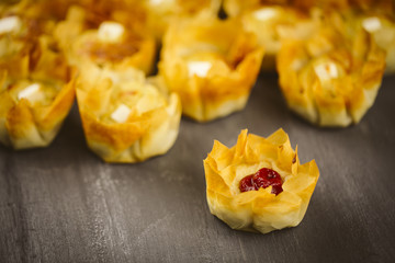 Puff pastries on a wooden background.