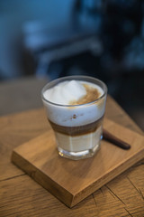 cappuccino or Latte art coffee made from milk on the wood table in coffee shop