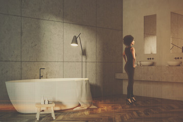Gray tile bathroom corner, white tub, toned