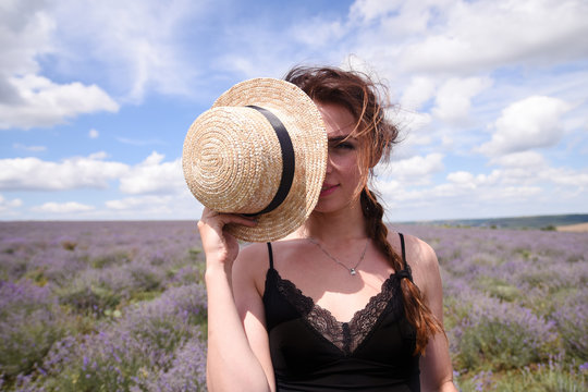A woman in a straw hat in a lavender field