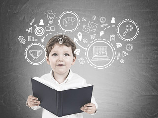 Cute little boy with a book, business strategy