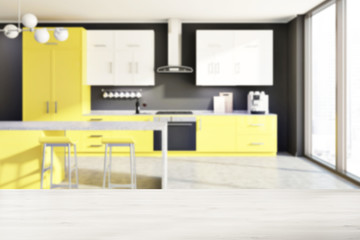 Gray kitchen, yellow counters, table blur