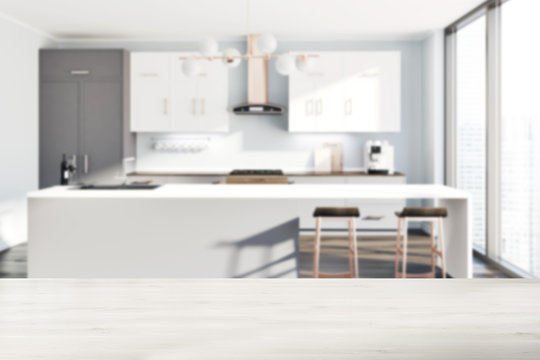 White kitchen, gray counters, table blur