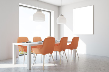 White dining room, orange chairs, poster