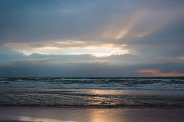 Naklejka na ściany i meble sunrise on the beach among the clouds