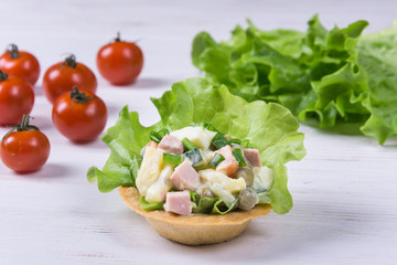 Traditional russian salad Olivier in tartlet