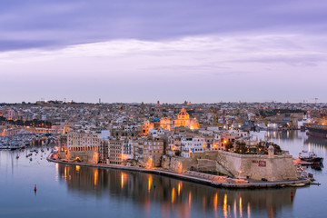 Fototapeta na wymiar Illuminated skyline of Senglea at twiligh sunset,Malta