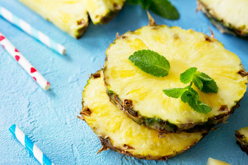 Fresh slice pineapple on stone background or slate with copy space. Food concept.