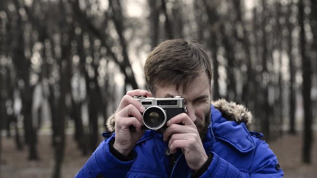 man shoots a classic rangefinder film camera.