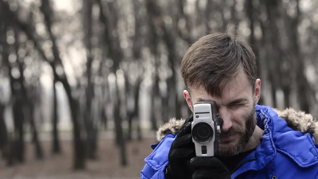 man shoots a movie camera.