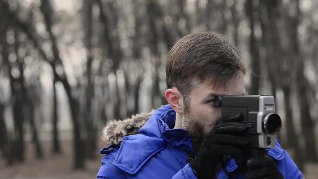 man shoots a movie camera.
