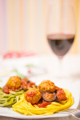 Pasta with meatballs, tomatoes and eggplant