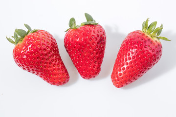 Strawberries fruit in a white background composition