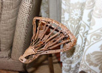 Antique rusty bicycle seat with no padding - springs showing - used as decor