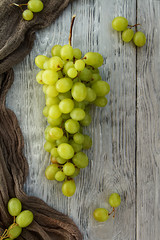 bunch green grapes on a grey wooden background