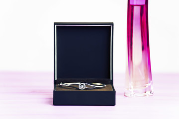 silver bracelet with a diamond in a box