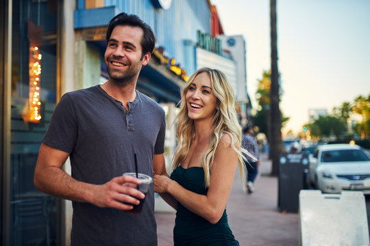 attractive romantic couple spending time together on sidewalk in los angeles