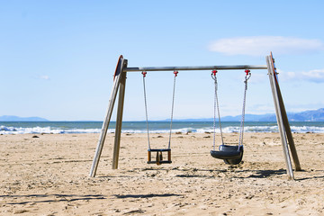 background wooden swing on the beach