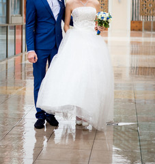 The bride and groom are walking in the park