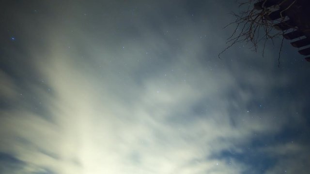 Night sky timelapse of clouds and stars.