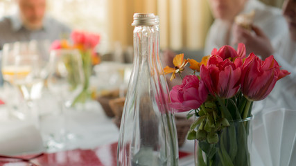 festive table with glasses and tulips