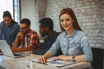 Young business woman posing at a meeting