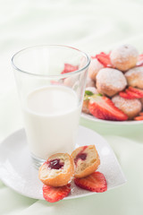Breakfast in a light key. Milk and pastries with strawberries