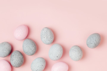 Stylish background of pale pink and gray Easter eggs. Dyed Easter eggs. Flat lay