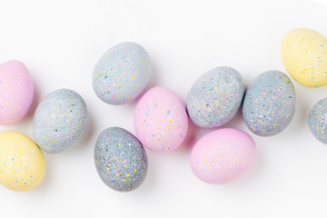 Background with pale pink, blue, yellow and gray Easter eggs. Compositions in pastel colors.  Easter concept
