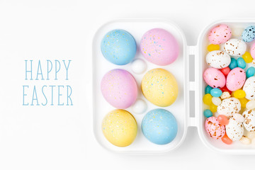 Easter eggs and candies in a box. Compositions in pastel colors.