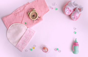 accessories for the baby, hat, baby's undershirt, bootees, pacifier, rhinestones, toy, alarm clock, watch.