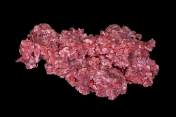 A pile of fresh raw minced meat isolated on a black background