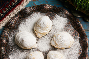 Badambura powdered pastry on Novruz tray. Azerbaijan traditional pastry cookie badambura on rustic table background