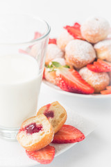 Breakfast in a light key. Milk and pastries with strawberries