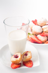 Breakfast in a light key. Milk and pastries with strawberries