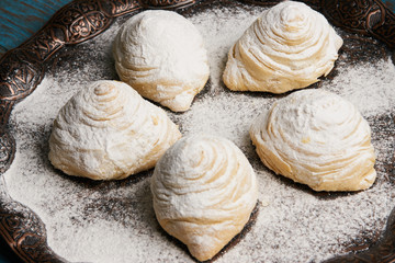 Badambura powdered pastry on Novruz tray. Azerbaijan traditional pastry cookie badambura on rustic table background