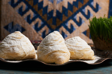 Badambura powdered pastry on Novruz tray. Azerbaijan traditional pastry cookie badambura on rustic table background