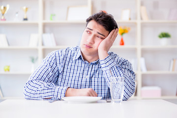Naklejka premium Man on diet waiting for food in restaurant