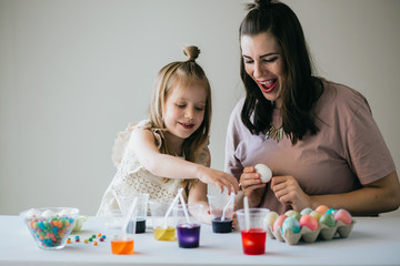 Mother and Daughter Painting Easter Eggs together