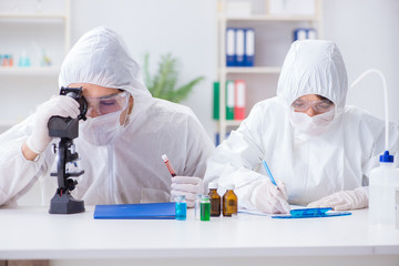 Two scientists working in the chemical lab