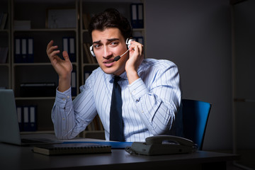 Tired and exhausted helpdesk operator during night shift