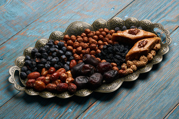 Traditional pakhlava baklava pastry on novruz tray with dry fruits snack. Azerbaijan national Novruz eastern new year spring celebration concept