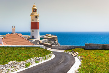 a view of the Trinity Lighthouse at Europa Point, in Gibraltar, and the Mediterranean sea - obrazy, fototapety, plakaty
