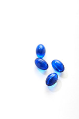 Blue pills capsule on white background