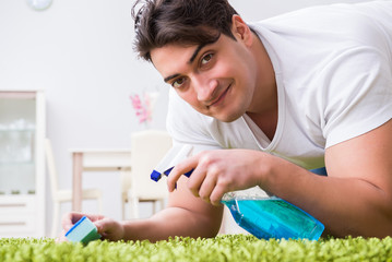 Young husband man cleaning floor at home