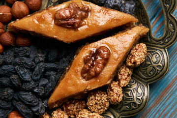 Traditional pakhlava baklava pastry on novruz tray with dry fruits snack. Azerbaijan national...