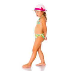 A small tanned girl in a swimsuit and a hat.