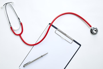 clipboard with red stethoscope and pen