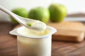 Eating of yummy apple yogurt, closeup
