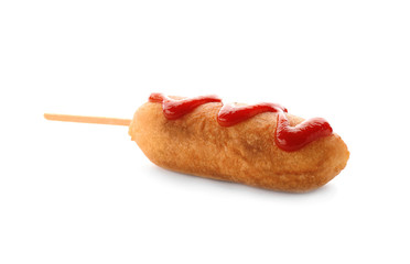 Tasty corn dog with ketchup on white background